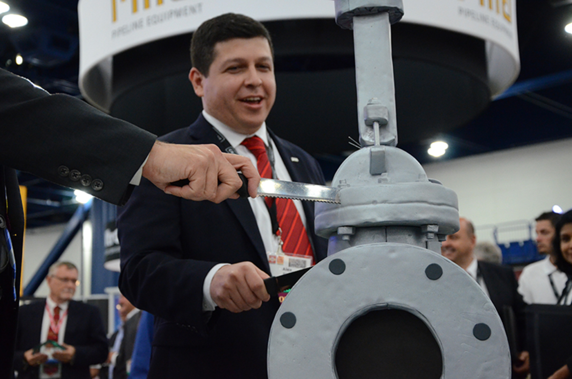 Crane President Alex Alcala cuts Crane&rsquo;s 160th anniversary cake in the shape of the new Pacific CSV gate valve at Valve World Americas Expo. (Courtesy Crane ChemPharma & Energy)