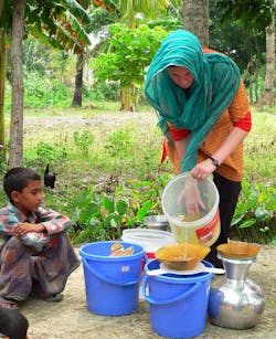 Dankovich pours contaminated pond water into a funnel containing an antimicrobial filter paper to obtain clean drinking water in a rural area of Bangladesh. (Photo credit: Ali Wilson) Dankovich pours contaminated pond water into a funnel containing an antimicrobial filter paper to obtain clean drinking water in a rural area of Bangladesh. (Photo credit: Ali Wilson)