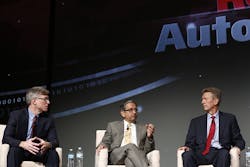 Blake Moret (left), senior vice president for Rockwell Automation, engages with customers during a panel discussion at Automation Fair 2015 about smart technology and data analytics for process optimization.