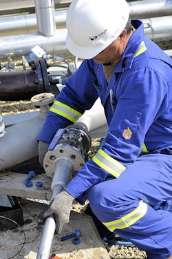 A quality engineer installs a new flare meter. A quality engineer installs a new flare meter.