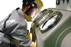 A 1962 photo shows the use of a glovebox for handling sensitive materials. Image courtesy of NASA A 1962 photo shows the use of a glovebox for handling sensitive materials. Image courtesy of NASA