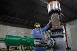 Figure 3. A technician installs an accelerometer on a globe valve with noise trim and vent diffuser to convert vibration to noise. All graphics courtesy of Emerson Automation Solutions