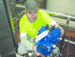 A plant technician with the installed electric actuator under evaluation