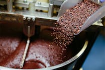 Cocoa grits are added into the chocolate-making process. primipil/iStock