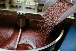 Cocoa grits are added into the chocolate-making process. primipil/iStock