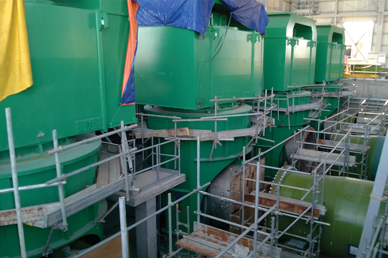 A series of large vertical pumps during installation. Image courtesy of Amin Almasi