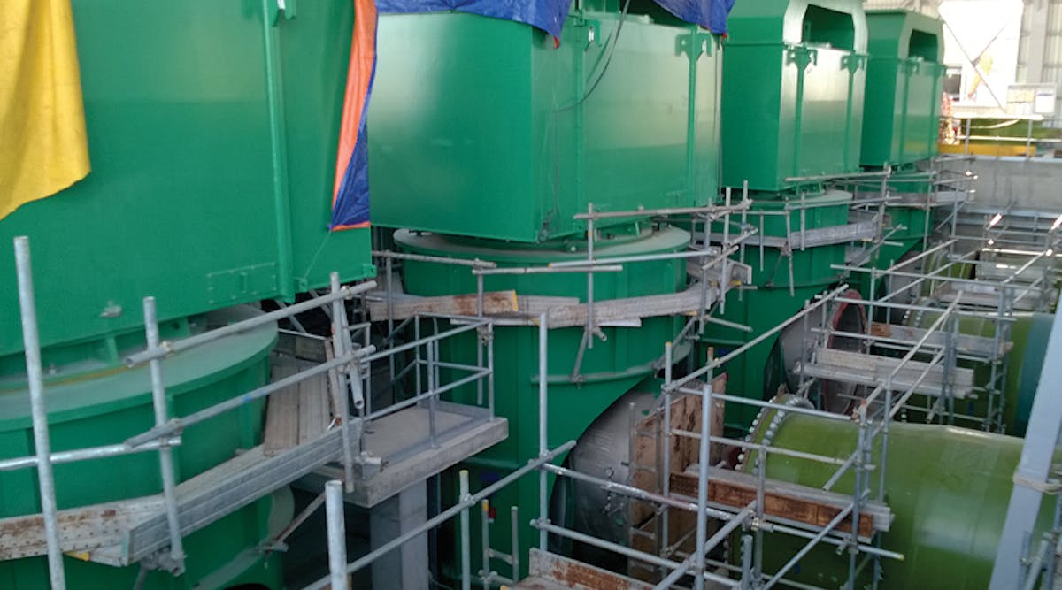 A series of large vertical pumps during installation. Image courtesy of Amin Almasi