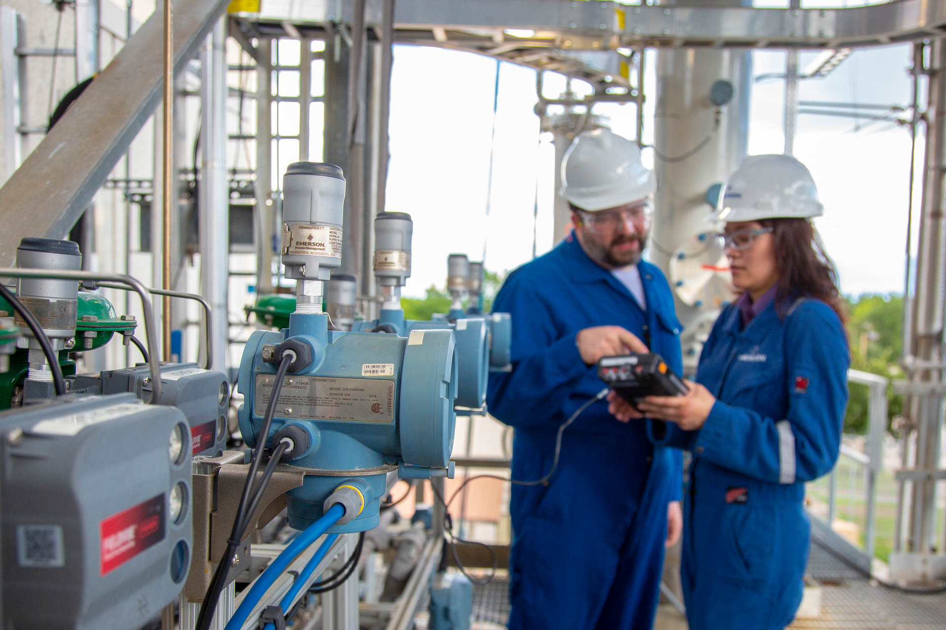 Figure 1. The cylindrical devices shown here &mdash; Emerson THUM wireless modules &mdash; are installed on Coriolis flowmeters.