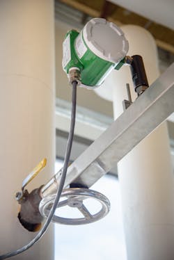 Figure 4. An insertion vortex flowmeter with handwheel retractor, metering steam entering a building. Figure 4. An insertion vortex flowmeter with handwheel retractor, metering steam entering a building.