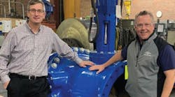 John Ballun and Rob McDonald standing next to a 30&apos; Tilted Disc Check Valve at Val-Matic&rsquo;s Elmhurst facility.