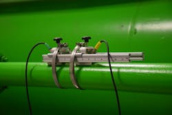 Figure 1: Clamp-on ultrasonic transducers mounted to water line. Figure 1: Clamp-on ultrasonic transducers mounted to water line.