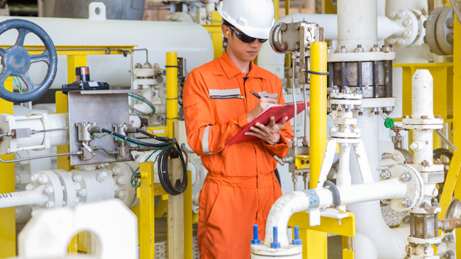 Figure 1. An operator checks and logs the value of a differential pressure gauge.